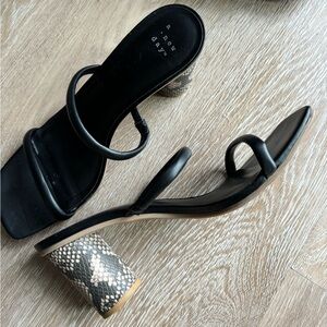 Black strappy heels with snakeskin heel